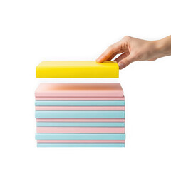 Hand placing a yellow sponge on a stack of colorful cleaning sponges
