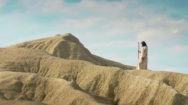 A Solitary Traveler ascending through vast desert landscape. Christian and spiritual concept