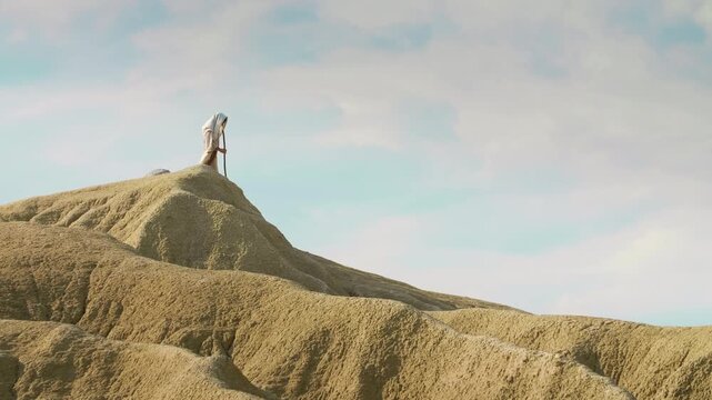 Solitary Traveler descending through vast desert. Christian and spiritual concept