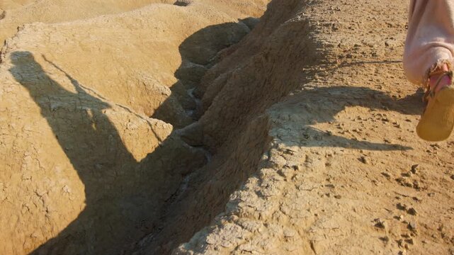 The solitary figure of the Messiah, wearing ancient robes, crossing a barren and rugged landscape. Christian and religious concept of the spiritual journey
