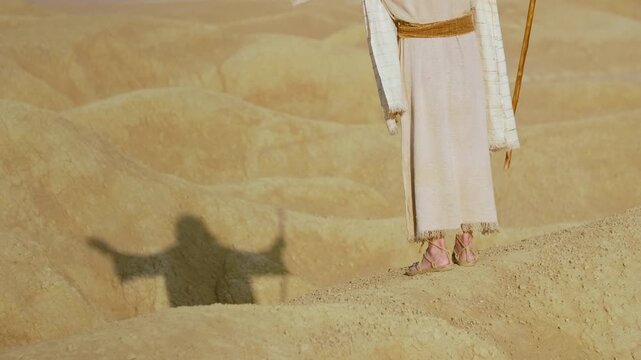 Representation of the Christ crossing a barren and rugged landscape. Christian and religious concept of the spiritual journey