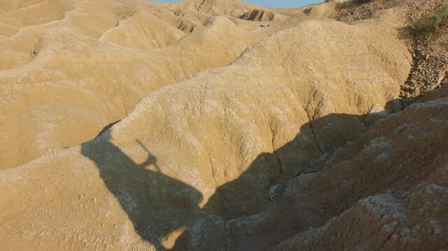 A solitary figure of Christ crossing a barren and rugged landscape in slow motion. Christian and religious concept of the spiritual journey