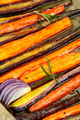 Healthy meal, seasoned roasted carrots, food background.