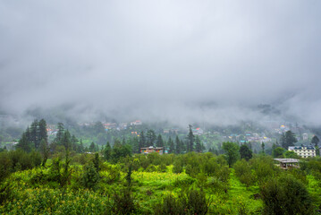 Old Manali town shrouded in misty clouds in Monsoon season. It is a popular Heaven for back packers and nature lovers for its natural beauty of Himalayas in Kullu region.