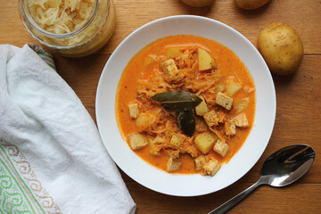 Healthy version of traditional Czech and Slovak cabbage soup (called zelnacka or kapustnica) cooked from sauerkraut, potatoes, cumin, sweet pepper, cream and smoked tofu cheese instead of sausage