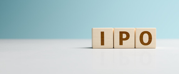 Wooden toy cubes forming the abbreviation 