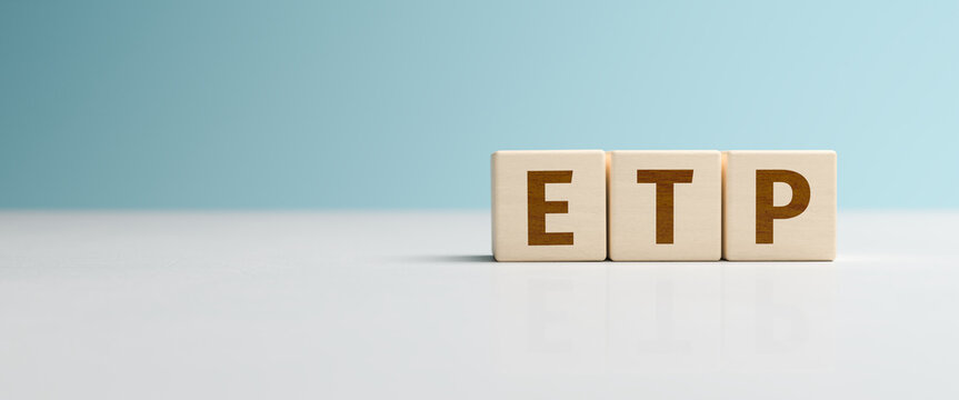 Wooden toy cubes forming the abbreviation "ETP". Exchange traded product