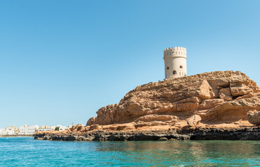 Historic Sur Watch Tower on a rocky promontory overlooking the Arabian Sea in Oman.
