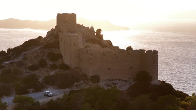 Aerial views of Kritinia Castle on a hill overlooking the Aegean Sea in Rodos Greece during the early morning hours
