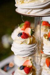 delicious wedding cakes with cream, berries and sweets