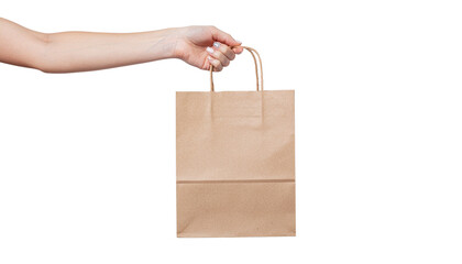 Hand holding a brown paper shopping bag with handles in a studio shot, isolated on a white backdrop solid white background and no background