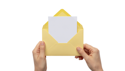 Hands holding a yellow envelope with a blank white card or letter partially visible inside isolated on white