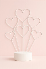 Minimal white podium with abstract heart wire decor on soft pastel pink background - romantic product advertising and branding concept
