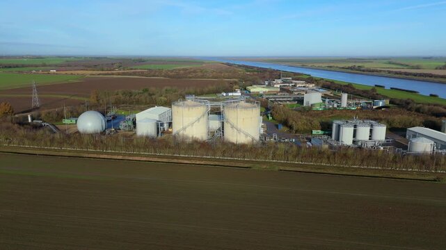 Industrial aerial drone scene of Anglian Water biosolids complex with sanitation infrastructure, sewage processing, tanks and ponds around Kings Lynn UK