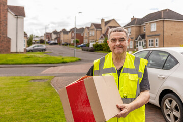 Courier Approaching Home While Carrying Online Shopping Parcel for Delivery