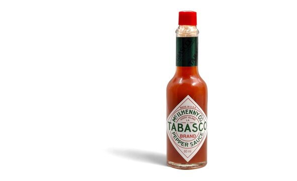 Photo of the classic Tabasco hot pepper sauce bottle by McIlhenny Company, a timeless Louisiana Avery Island creation since 1868, isolated on a white background.