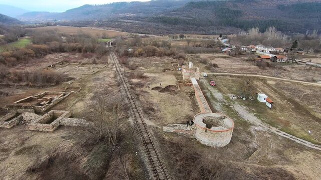 Drone video of Sostra Fortress in March 2019, showing the walls, surrounding ruins, the nearby railway, and tourists exploring the site, Troyan, BG, EU, 02 March 2019