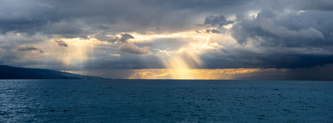Dramatic panoramic view of stormy Geneva lake at sunset in Switzerland