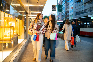 Generation z women enjoying city christmas shopping