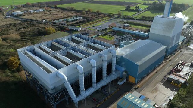 Drone footage showing the Kings Lynn power plant with tall chimney stack, smoke vents and energy production machinery forming a major UK industrial facility