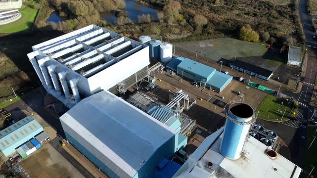 Large power plant in Kings Lynn with a large smoke stack chimney, smoke vents. Electrical energy generation coal gas and oil. Aerial drone view. 