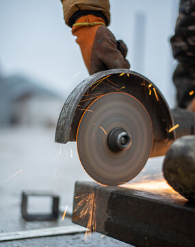 angle grinder in operation. A man saws metal, sending sparks. High quality photo