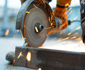 angle grinder in operation. A man saws metal, sending sparks. High quality photo