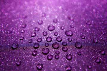 Close-up of water drops on a shimmering surface. 