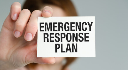 Emergency Response Plan text on card in hand business Women