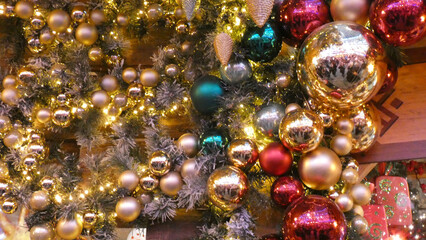 Festive holiday decorations with shiny ornaments and warm lights create a joyful atmosphere in a cozy indoor setting