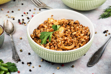 Bowl of buckwheat porridge on table.