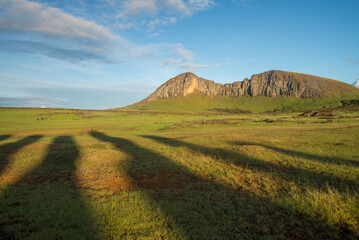 Moai statues cast shadows in golden sunlight, Easter Island, Chile