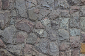 Finishing the building wall with stone.