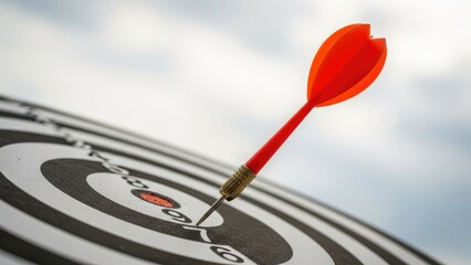 Red Dart Hitting Bullseye on Target Board Photo