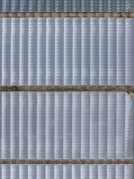 Aerial view of a textured surface with repetitive patterns and linear structures create a mesmerizing optical effect, Battipaglia, Campania, Italy.