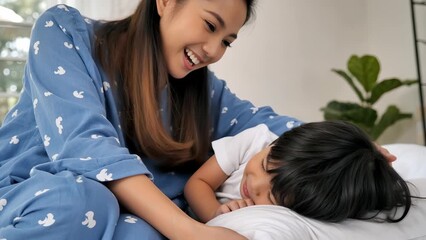Joyful Moments: A Young Asian Female and Child Sharing Laughter at Home
