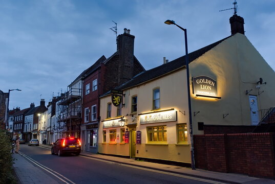 Golden Lion Pub lit up on the High Street at dusk. Nov 08, 2025: Boston Lincs. UK. 