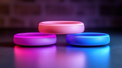 A close up of three circular objects stacked on top of each other with pink purple and blue lighting