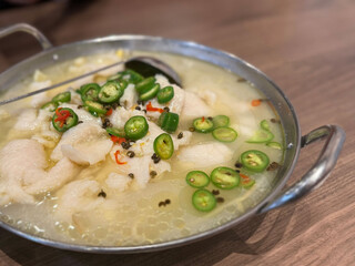 Fish fillets with green chilies and Sichuan pepper, finished with fragrant green Sichuan pepper oil