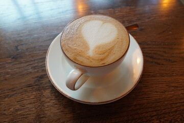 Latte art featuring a heart design served in a cozy cafe