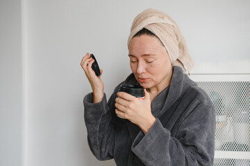 Woman applying facial scrub or beauty mask at home, skincare beauty routine and skin care regimen, self-care wellness