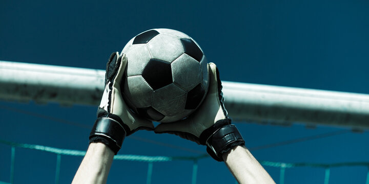 A Goal keeper grab a ball 