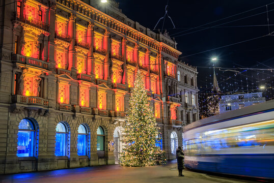 Magical scene with a Christmas tree, blur of a passing tram, Paradeplatz, Zurich