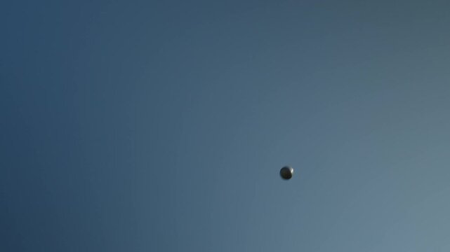 Flight of a shot shot against the background of the sky by an abandoned professional athlete