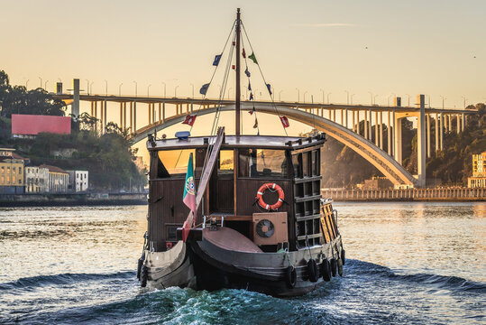 Tourist boat on the Douro River in Porto, view with Arrabida Bridge, Portugal - Powered by Adobe