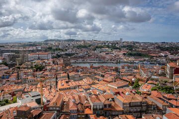 Naklejka premium Aerial view from tower of Clerigos Church in Porto city, Portugal with Douro River and Vila Nova de Gaia city on background