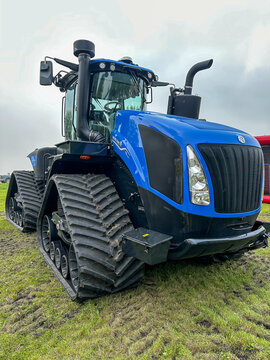 ROSEAU, MN - 23 JUL 2025: New Holland T9 700 farm tractor with tracks in close up, right front view.