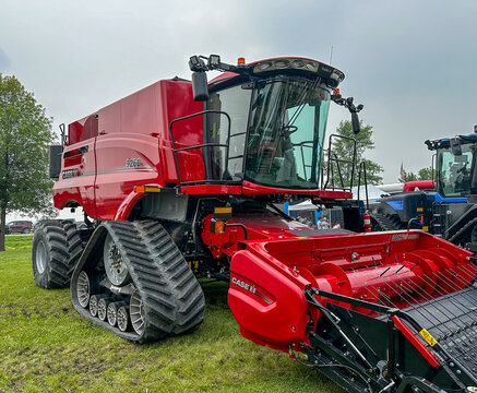 ROSEAU, MN - 23 JUL 2025: CaseH 9260 Axial Flow combine harvester farm implement with front tracks in a right front, angled view, on a cloudy day.