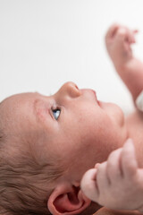 Newborn baby waking up with blue eyes