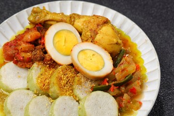 Lontong cap go meh is a Chinese Indonesian Peranakan consisting of lontong served with chicken opor, vegetables, fried liver sambal, egg, beef, sambal, and crackers. Lontong sayur or lontong opor